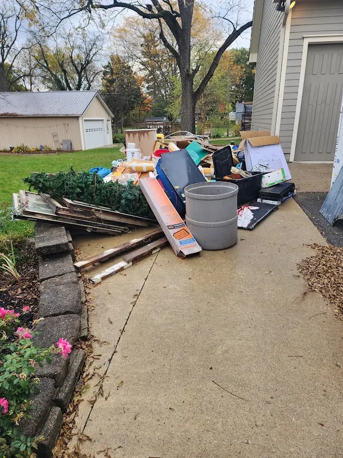 Dumpster being loaded with debris for Demolition Dumpster Rental in Sand Lake